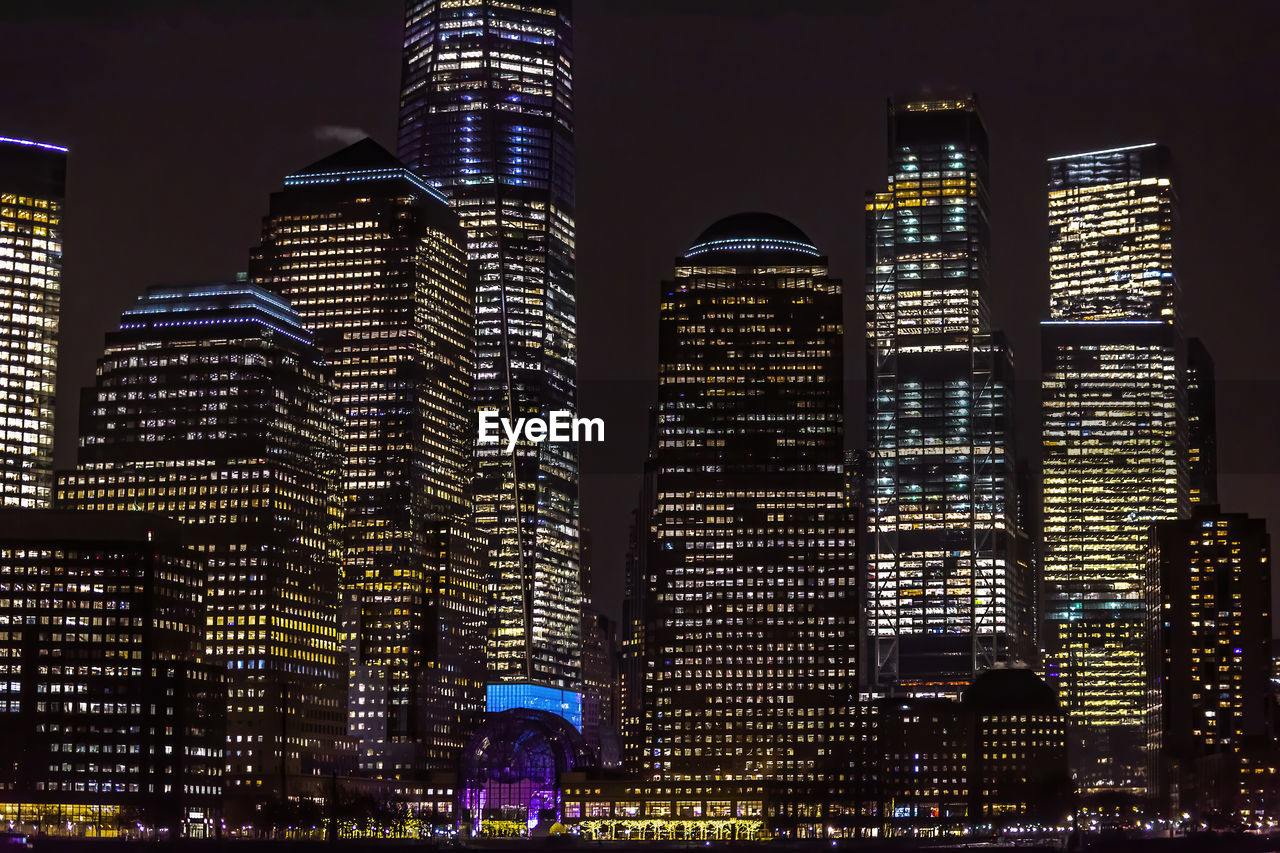 Illuminated buildings against sky at night