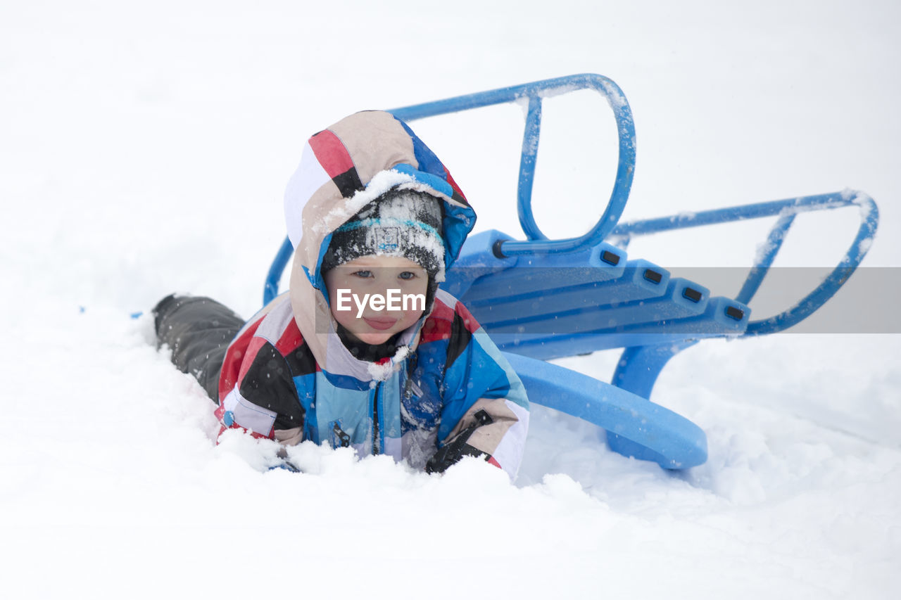 Portrait of boy playing on covered field