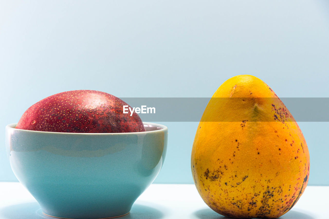 CLOSE-UP OF FRUITS IN GLASS ON TABLE