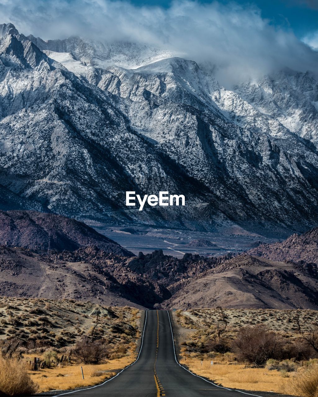 View of mountain road against cloudy sky