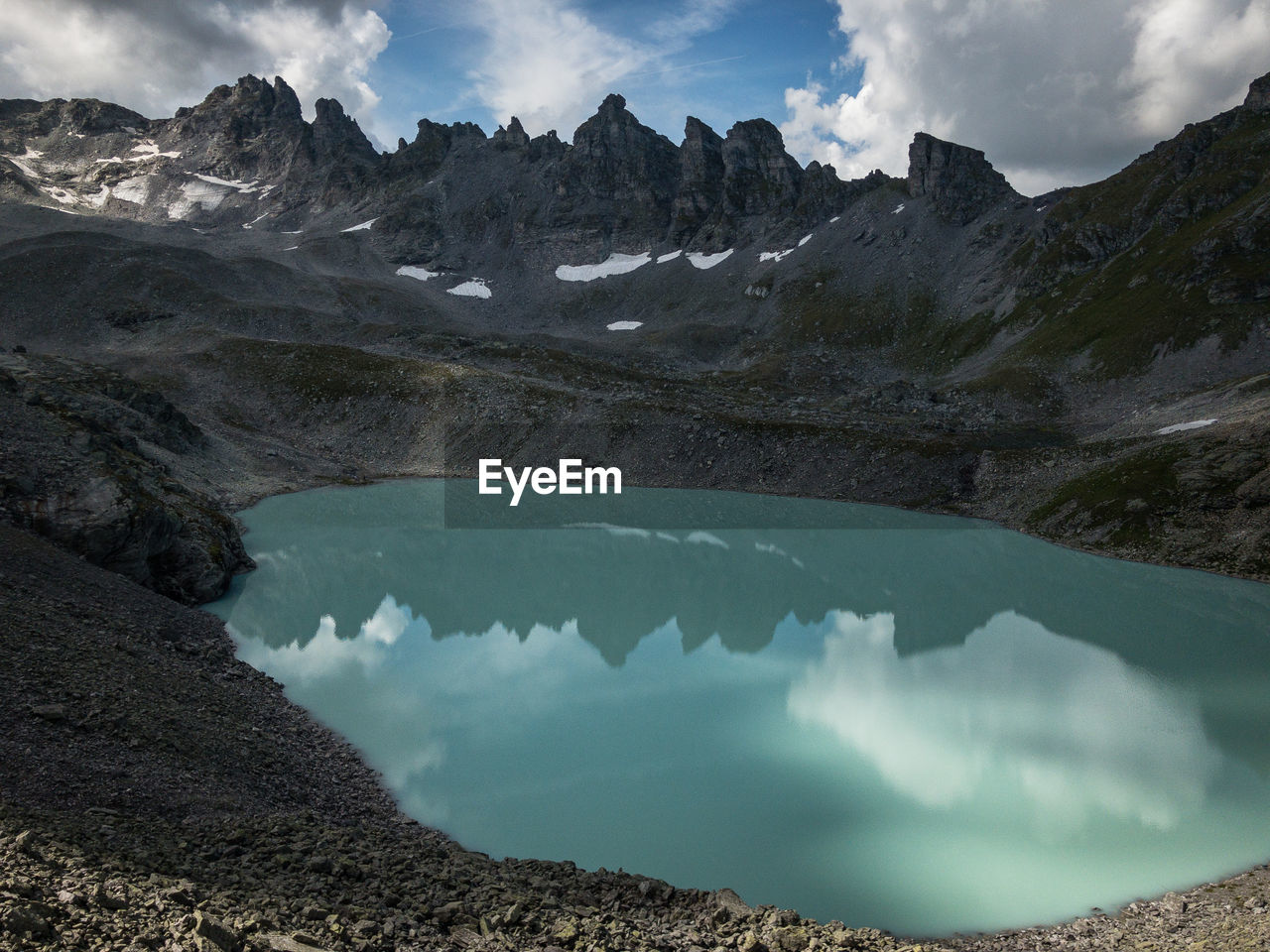Scenic view of lake and mountains against sky