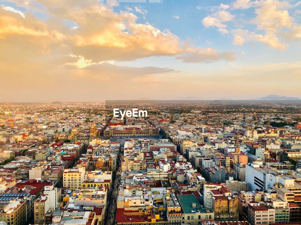 High angle shot of townscape against sky at sunset