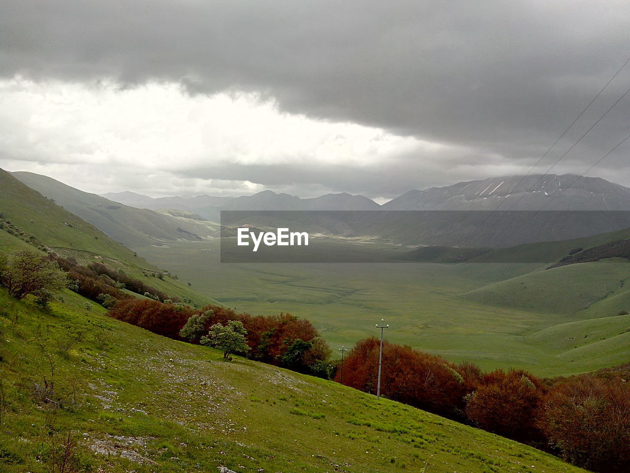 Scenic view of mountains against cloudy sky