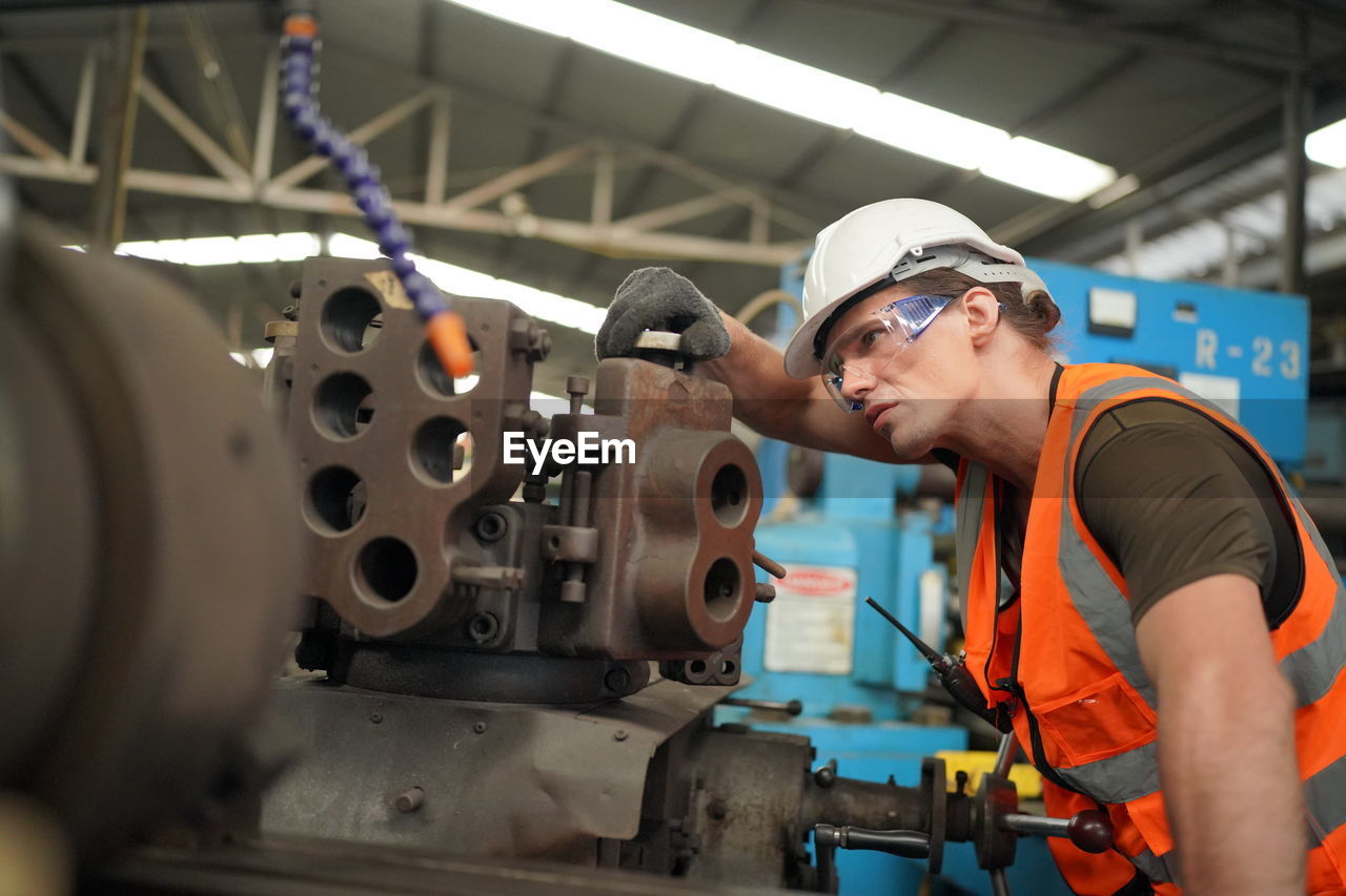 side view of man working at factory