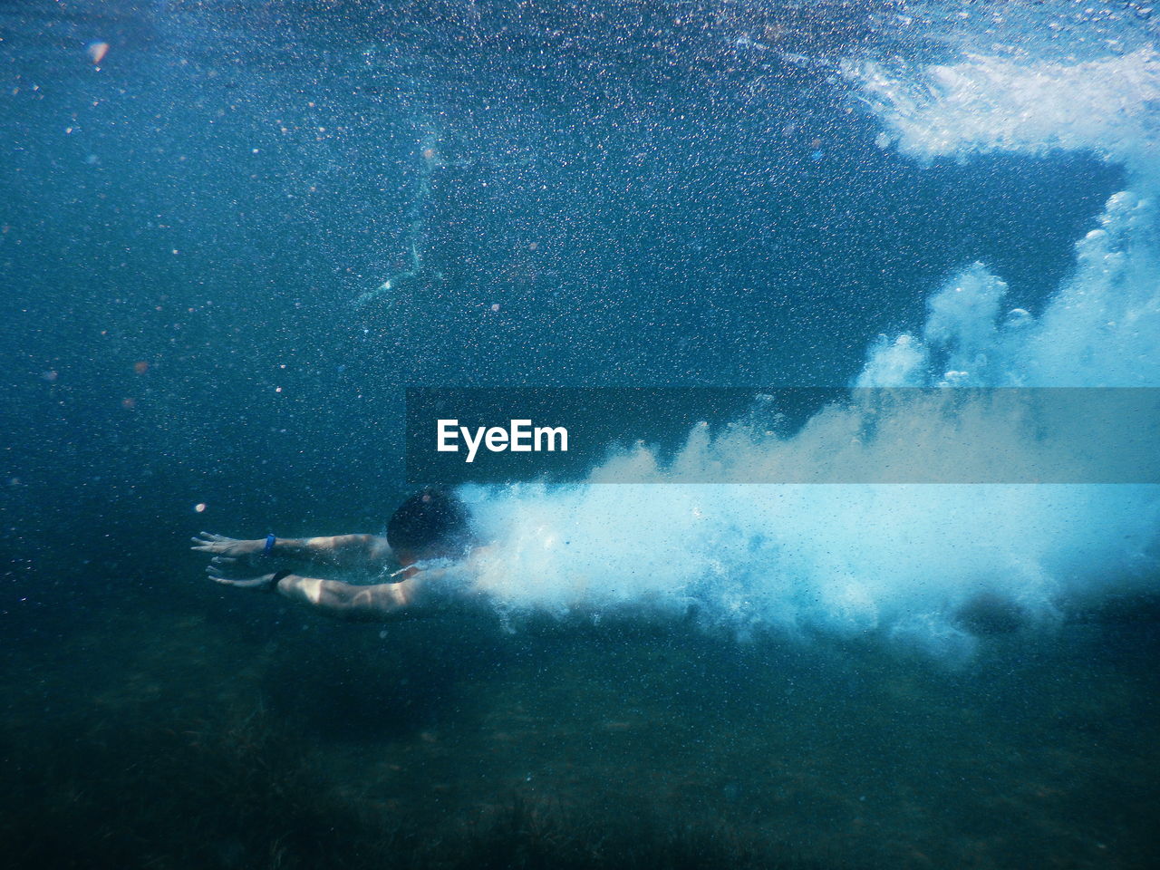 Young woman swimming in undersea