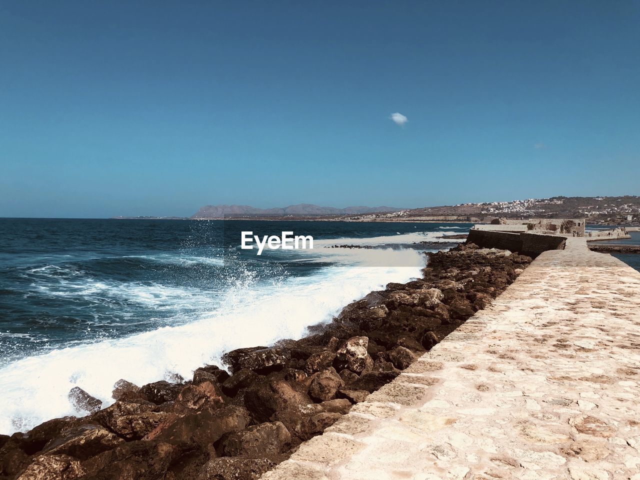 Scenic view of sea against clear blue sky