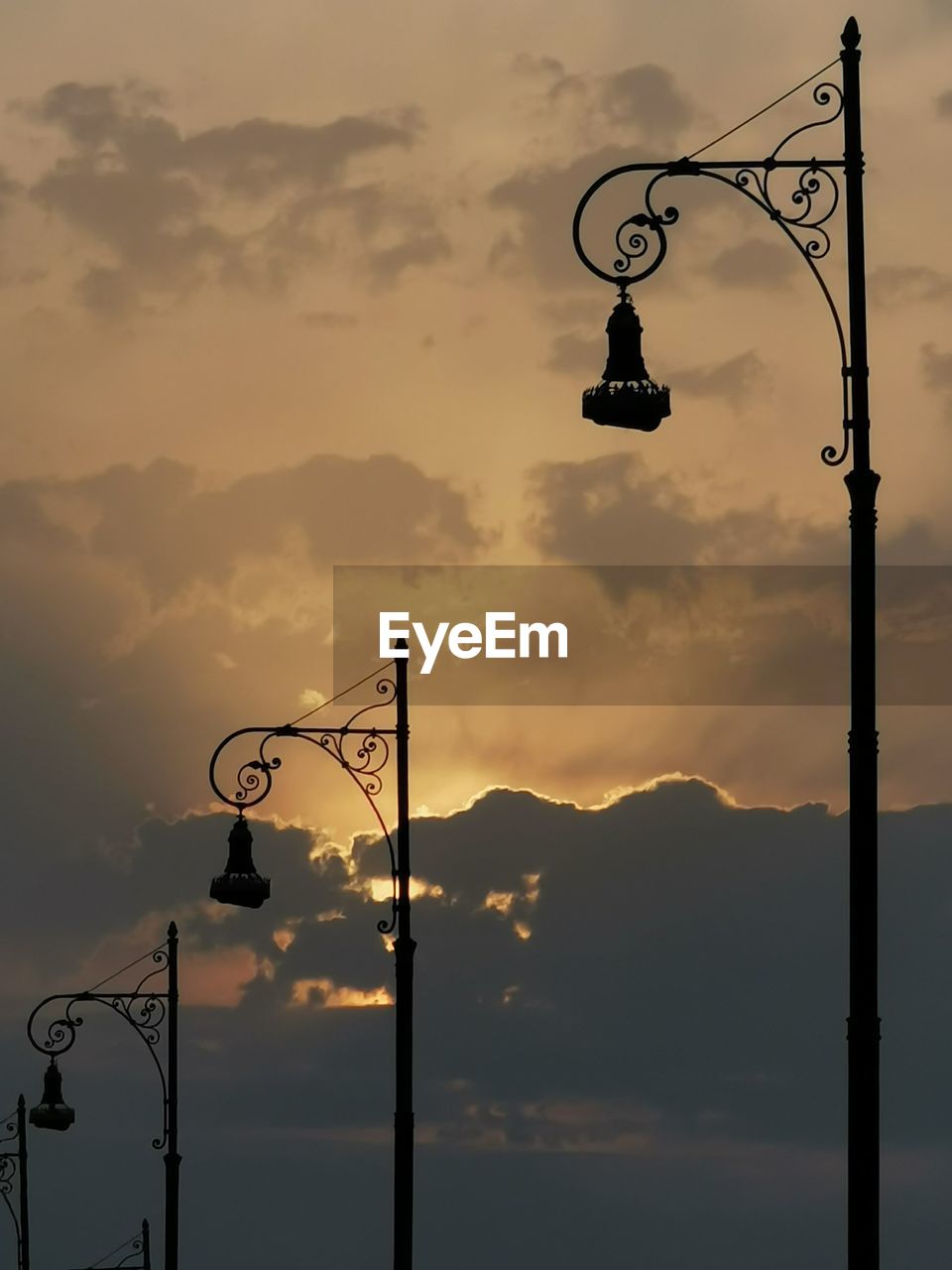 Low angle view of street light against sky during sunset