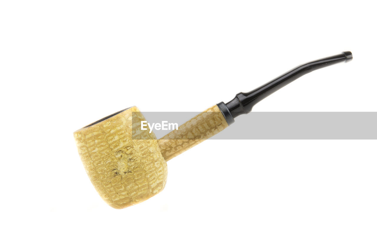 Close-up of smoking pipe against white background