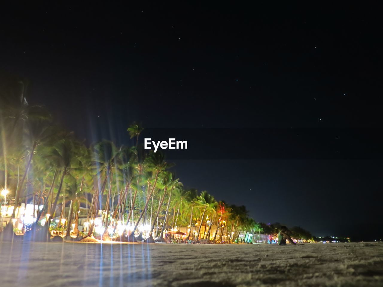 ILLUMINATED BEACH AGAINST SKY