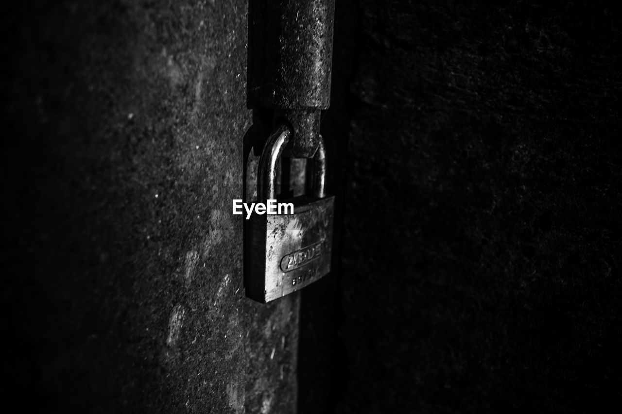 CLOSE-UP OF PADLOCKS ON METAL CHAIN