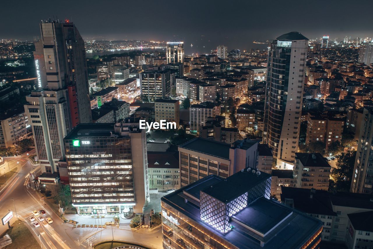 High angle view of illuminated buildings in city at night