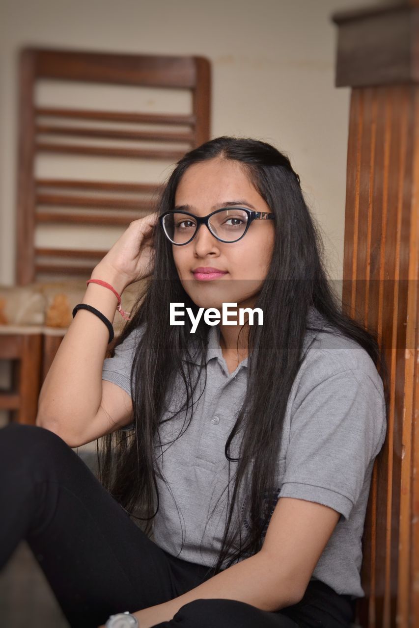 Portrait of young woman sitting at home