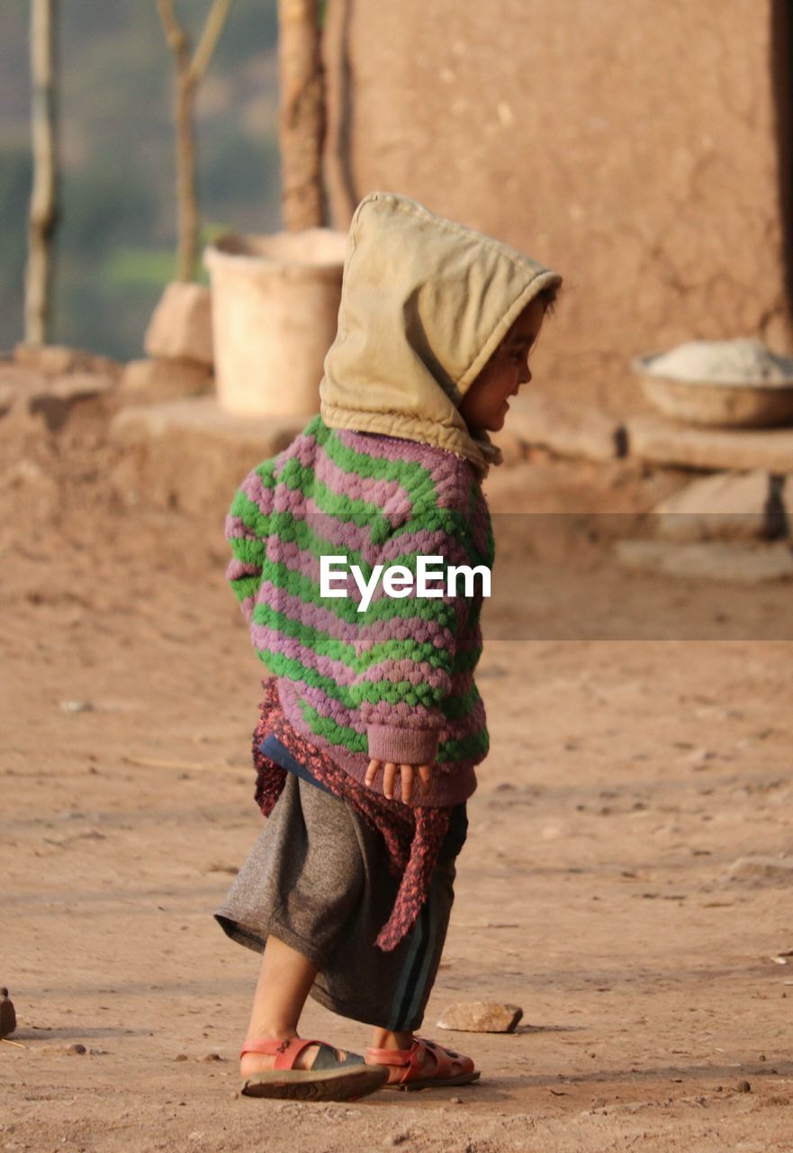 Rear view of girl standing outdoors