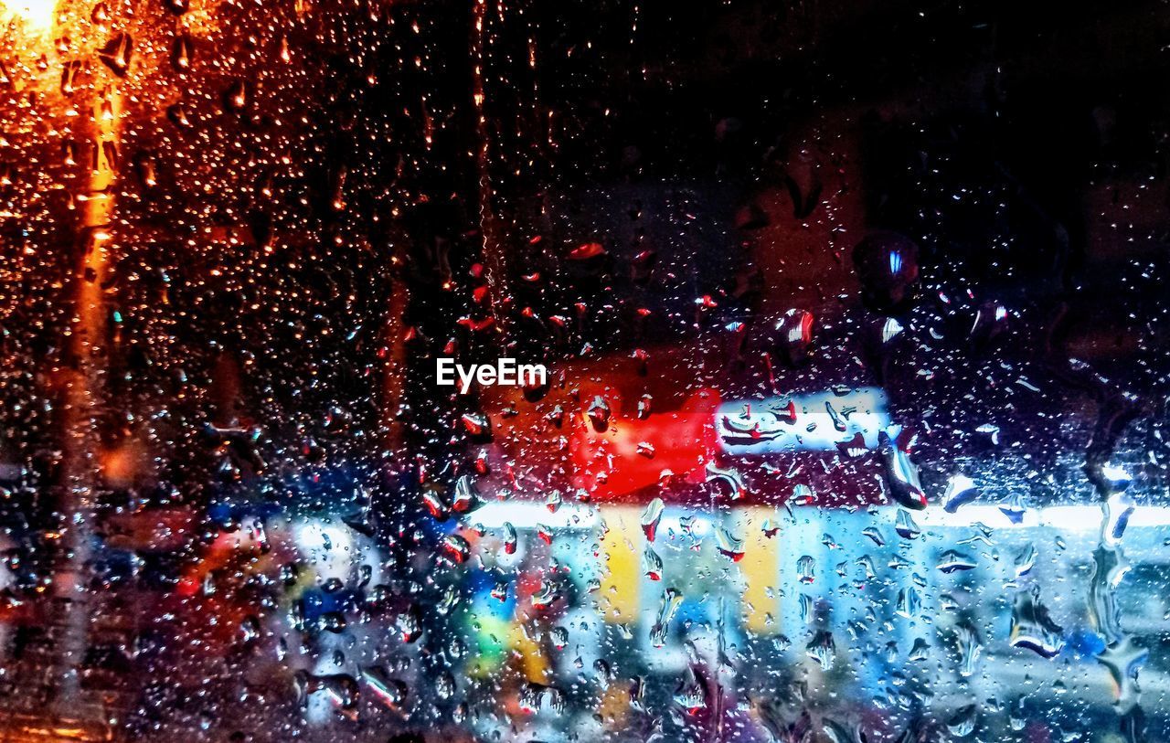 Rain drops on glass window of car