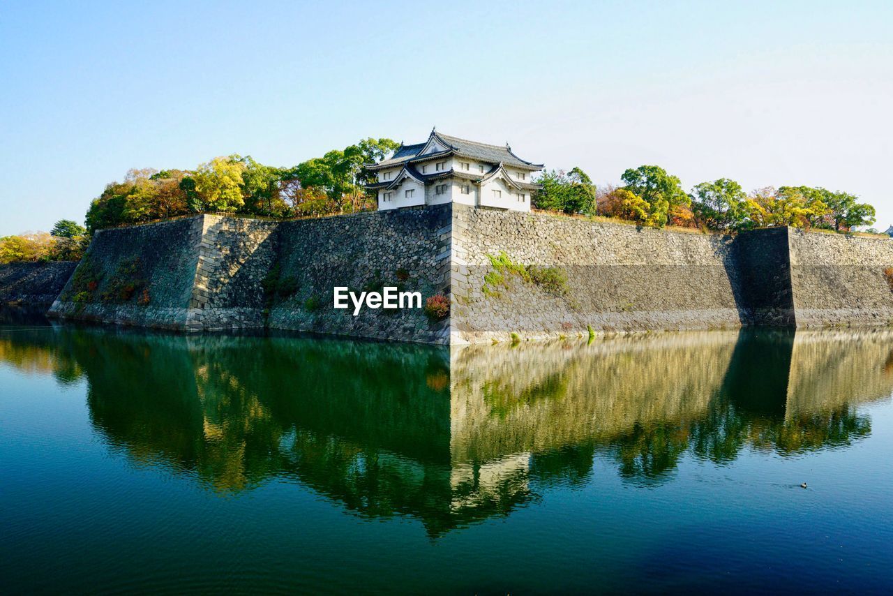 Scenic view of lake against clear blue sky