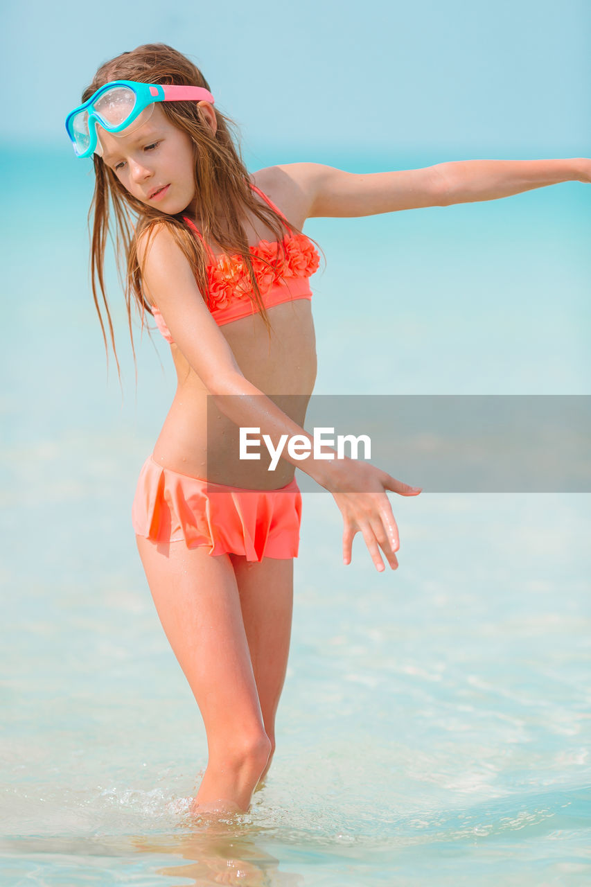 Girl standing in sea