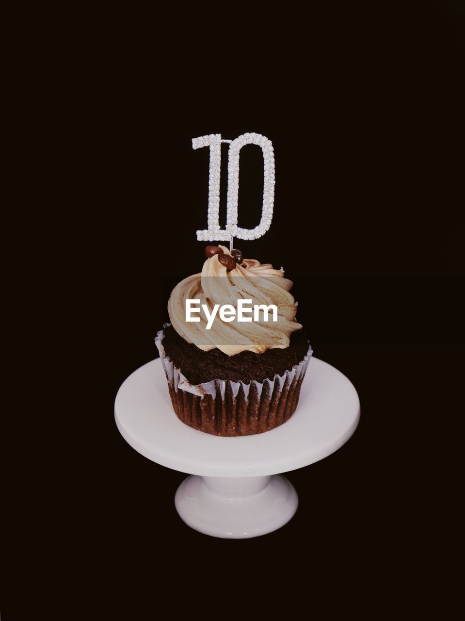 VIEW OF CUPCAKES AGAINST BLACK BACKGROUND