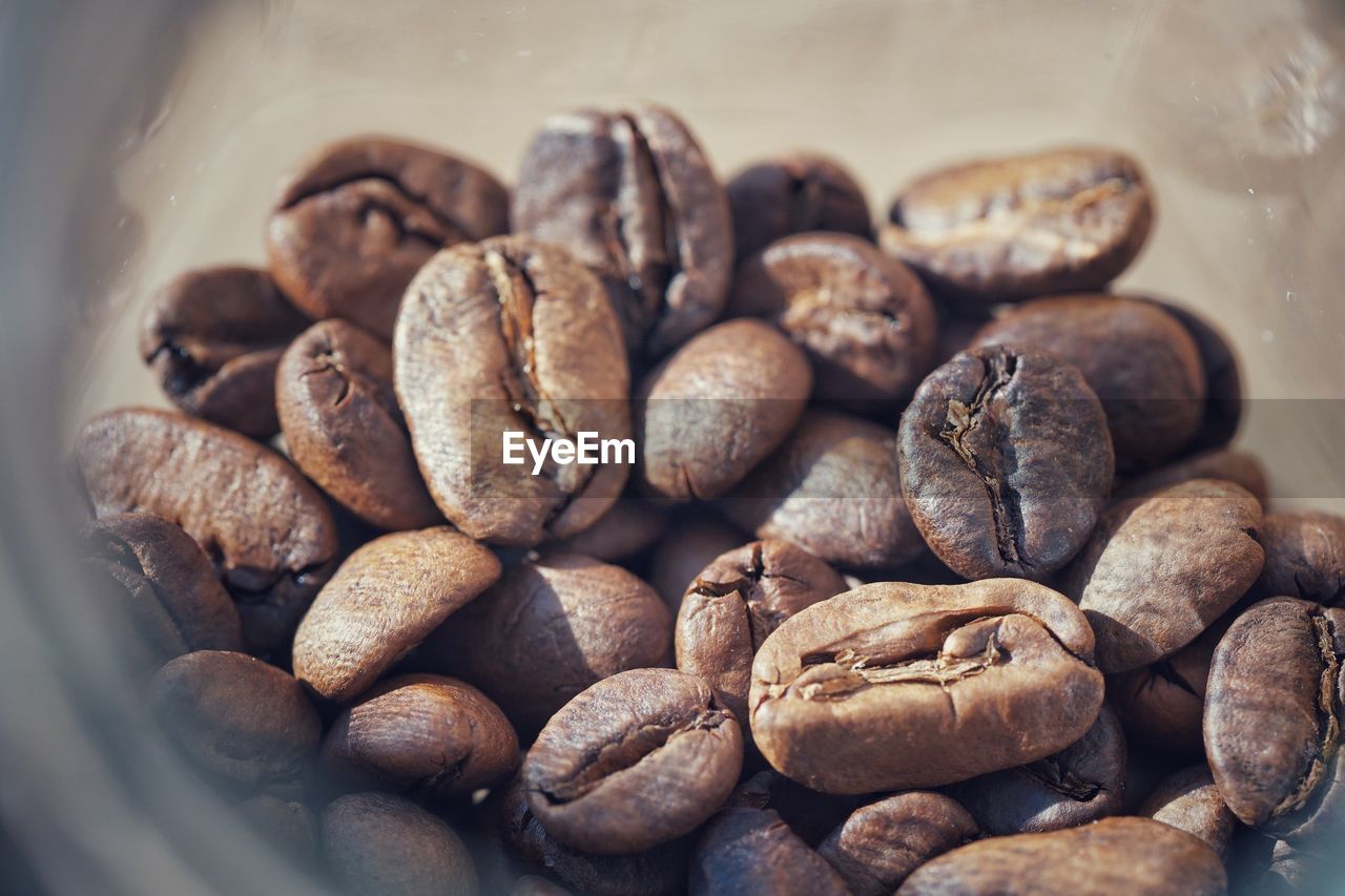 CLOSE-UP OF COFFEE BEANS IN CONTAINER