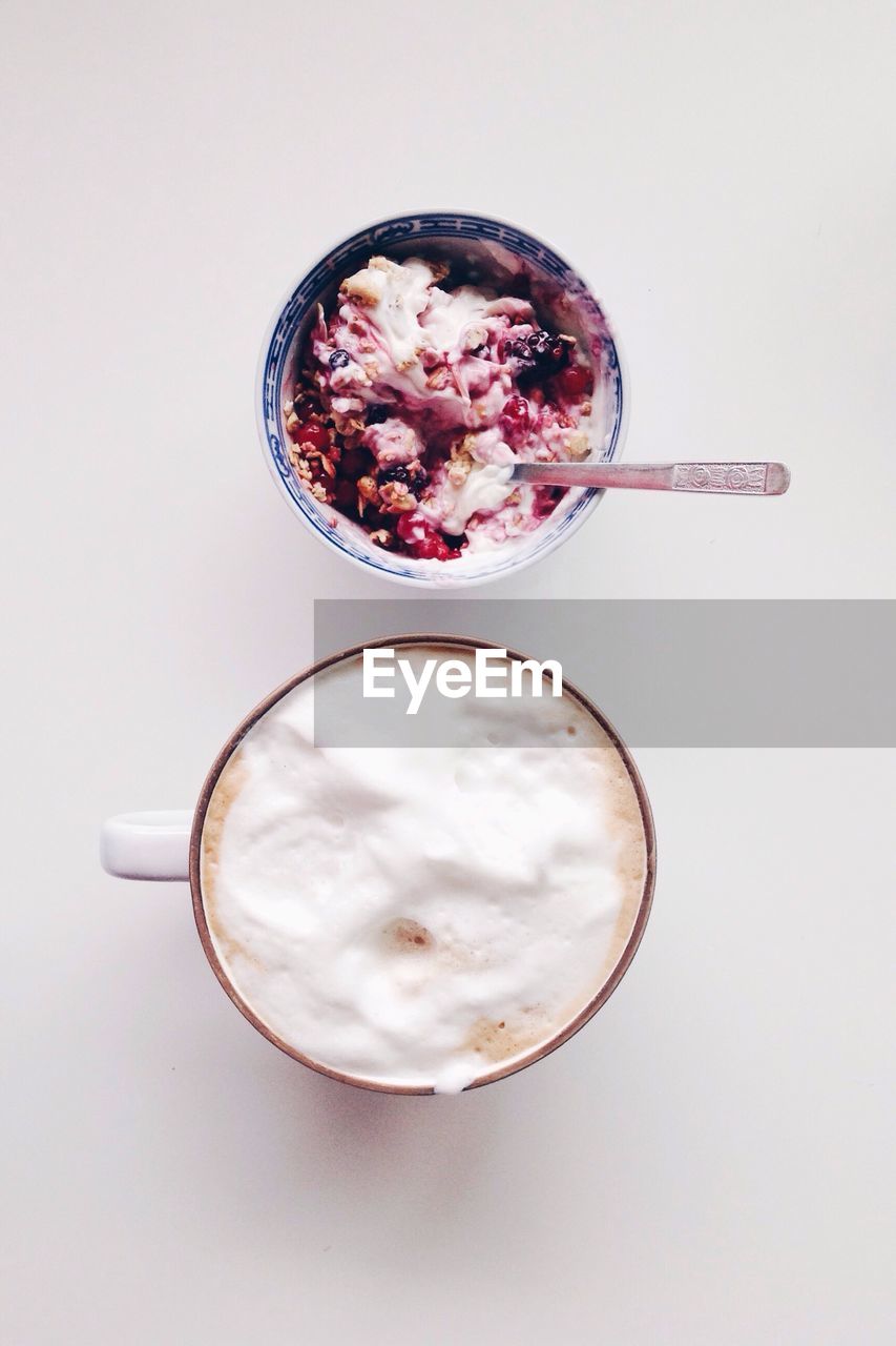 Directly above shot of breakfast on table against white background