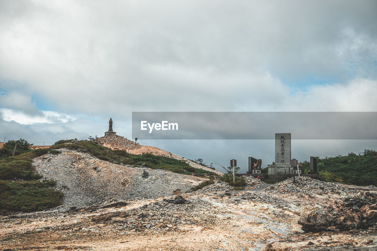 cloud, sky, architecture, hill, sea, built structure, history, landscape, environment, the past, coast, nature, travel destinations, ruins, rock, travel, building exterior, building, land, scenics - nature, tourism, tower, cliff, ancient, overcast, outdoors, no people, rural area, beauty in nature, fort, fog, terrain, religion, storm, old ruin, city, holiday, trip, cloudscape, dramatic sky, day, vacation