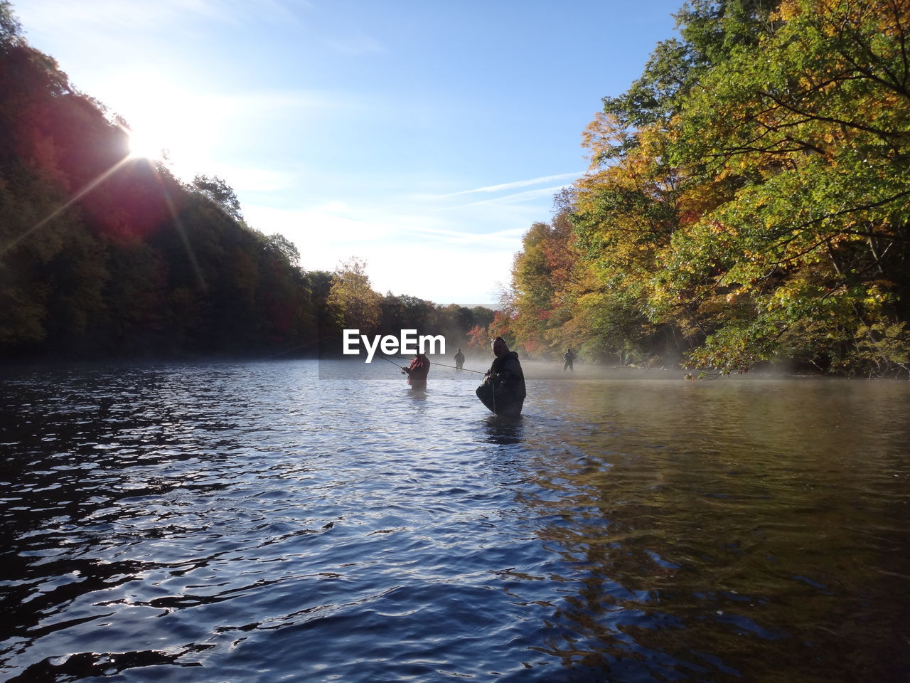 People fishing in river