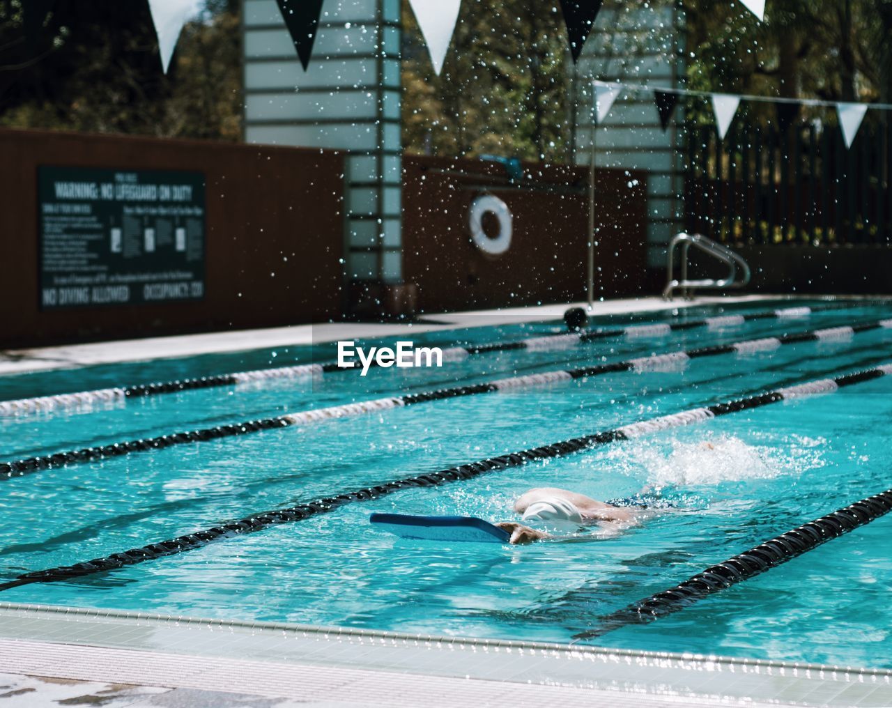 Person swimming in blue pool