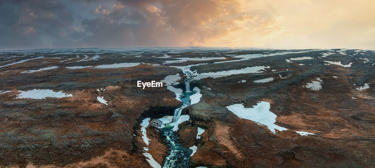 Aerial view on hengifoss waterfall with red stripes sediments in iceland.