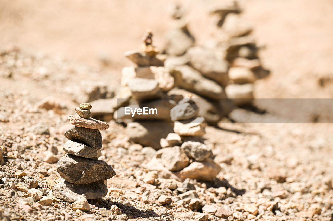 Close-up of stone stack on sand