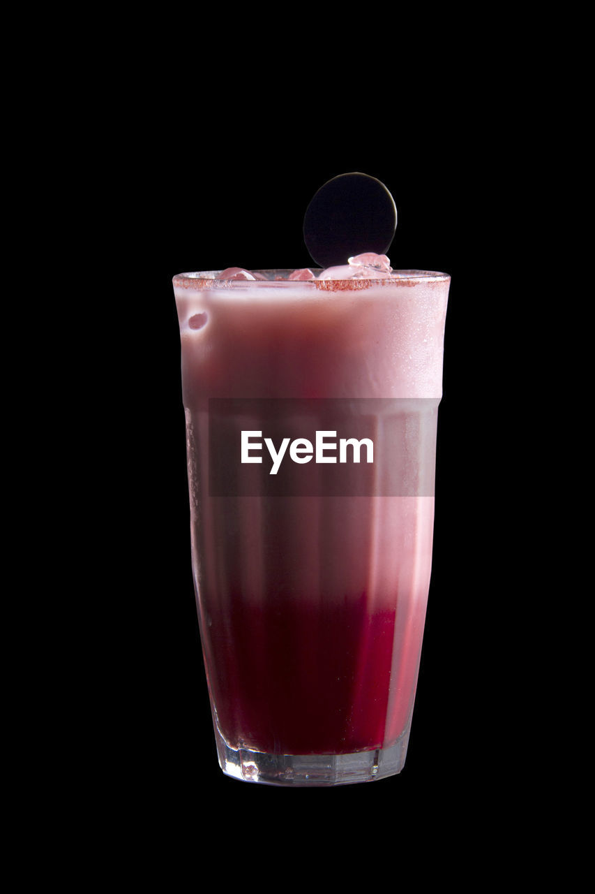 Close-up of drink in glass against black background