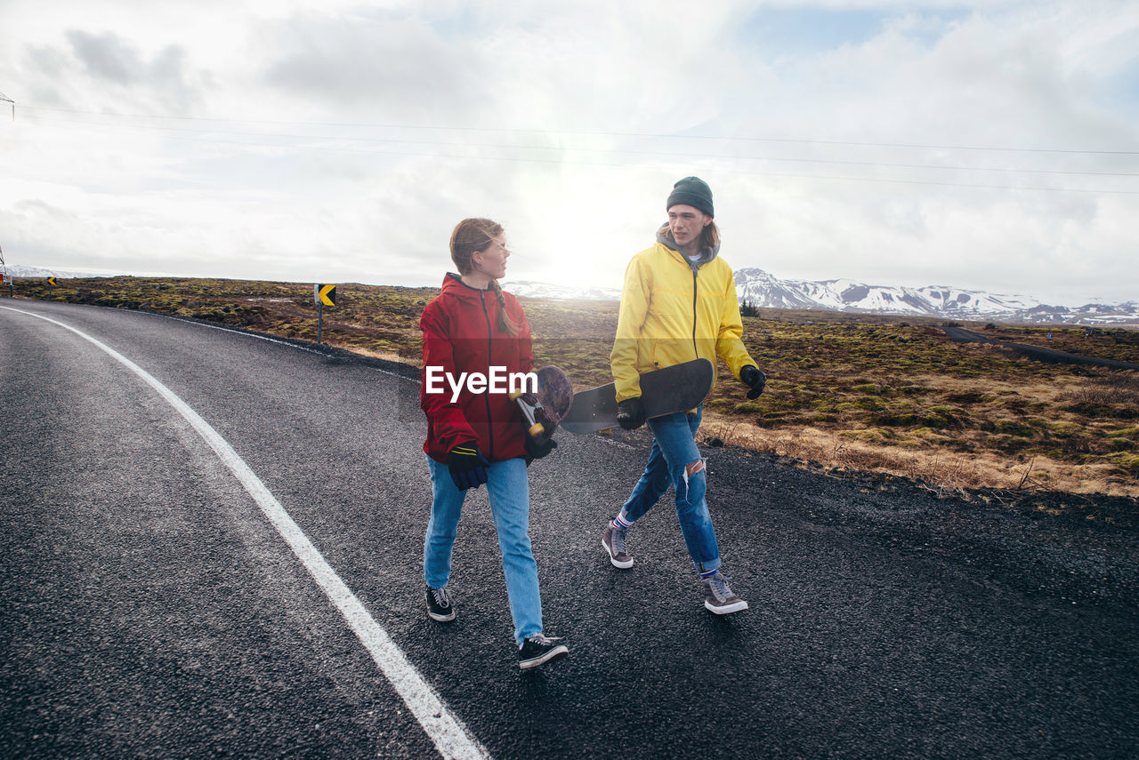 MAN ON ROAD AGAINST SKY