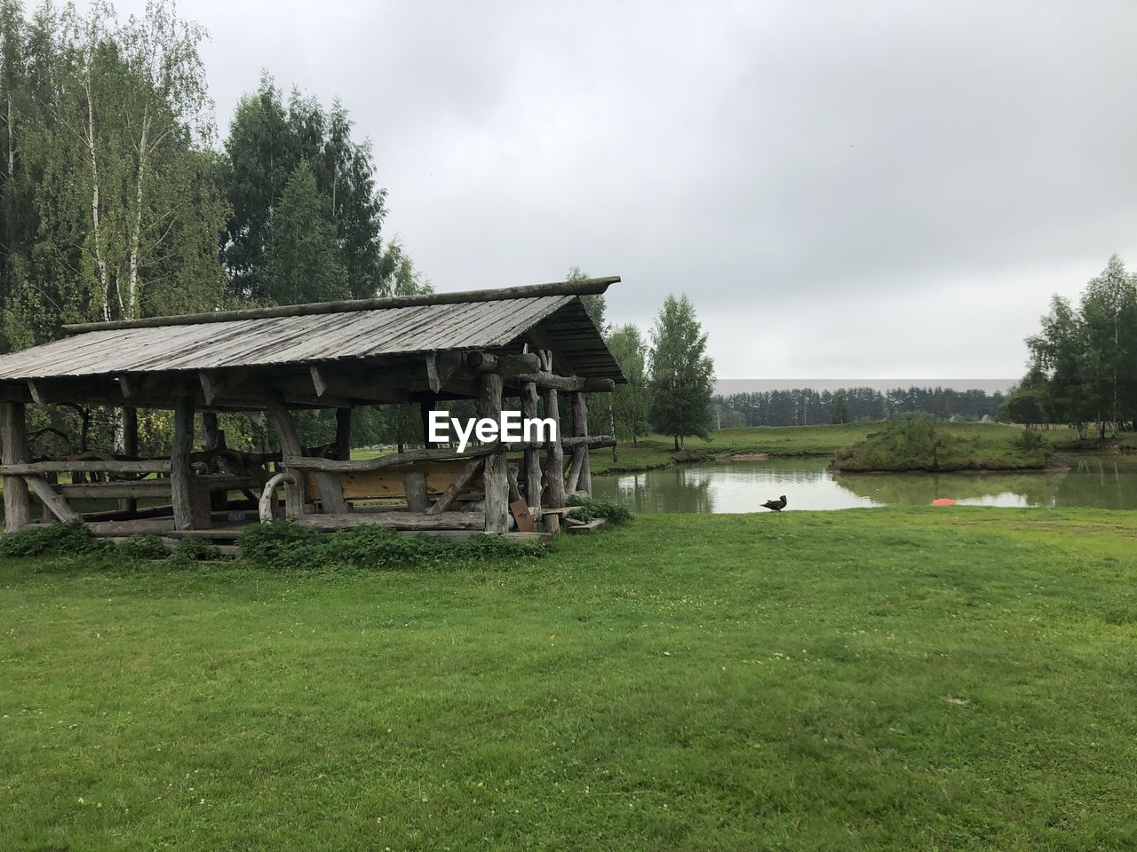 HOUSE ON FIELD AGAINST SKY