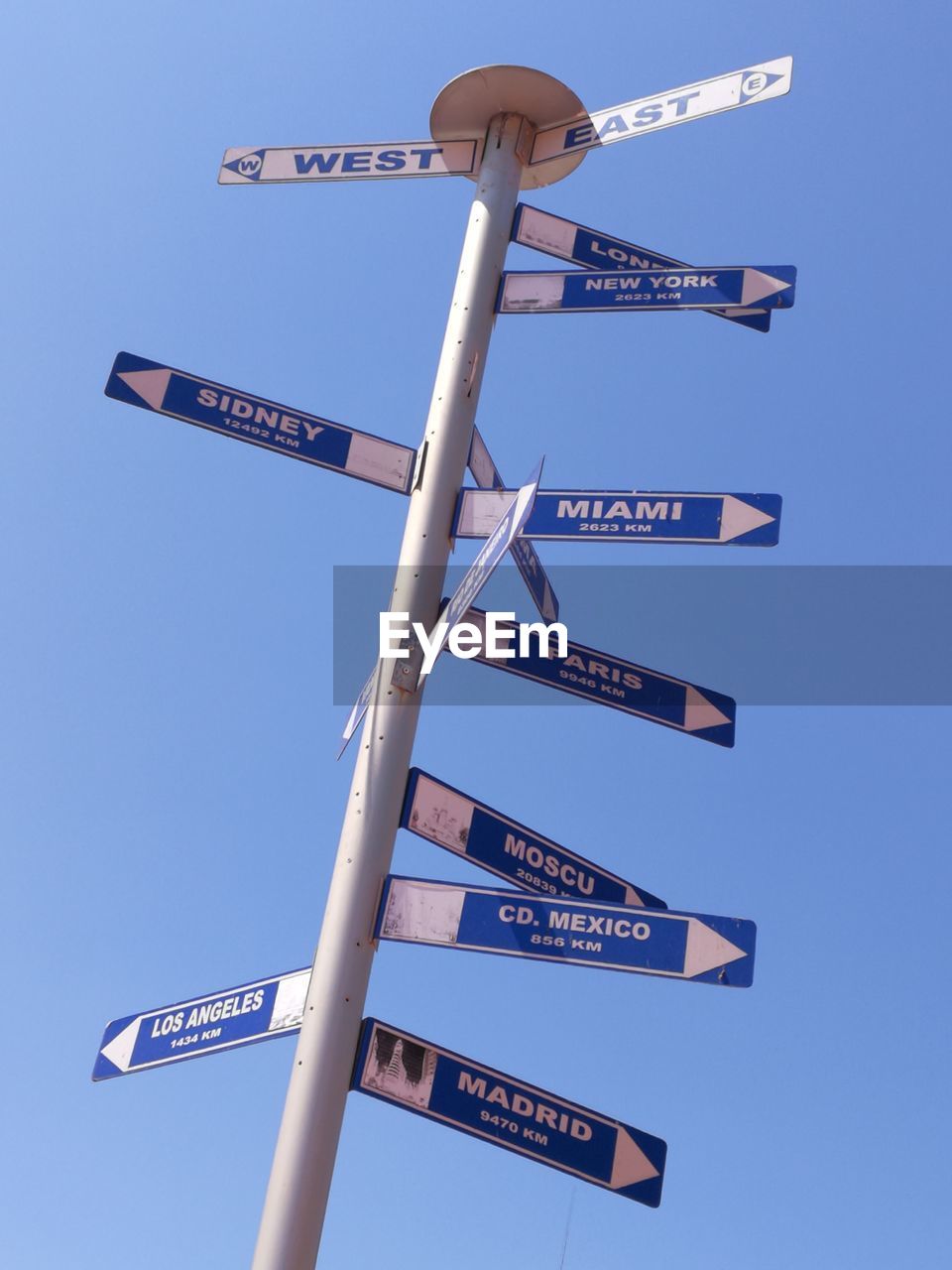 LOW ANGLE VIEW OF ROAD SIGN AGAINST BLUE SKY