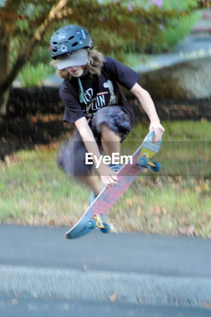 WOMAN STANDING ON SKATEBOARD