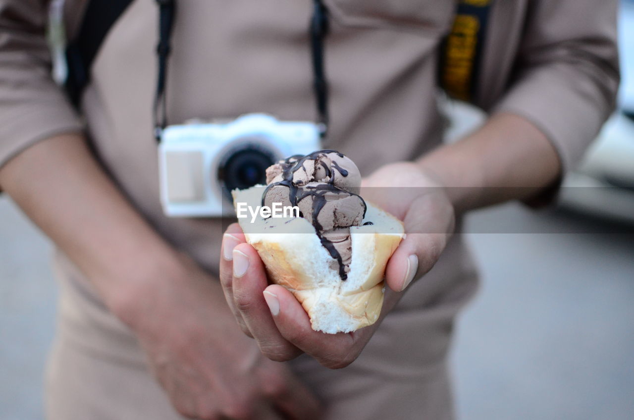 Midsection of man holding ice cream