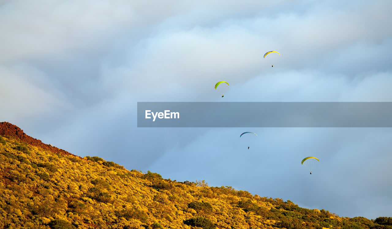 People paragliding over el teide national park