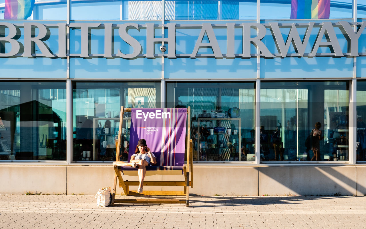 MAN SITTING IN GLASS WINDOW