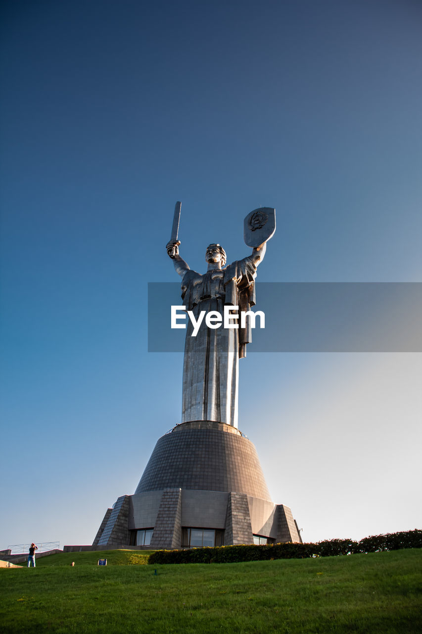 sky, landmark, statue, sculpture, monument, architecture, nature, blue, travel destinations, clear sky, grass, travel, no people, human representation, history, outdoors, the past, memorial, day, environment, built structure, religion, landscape, representation, copy space