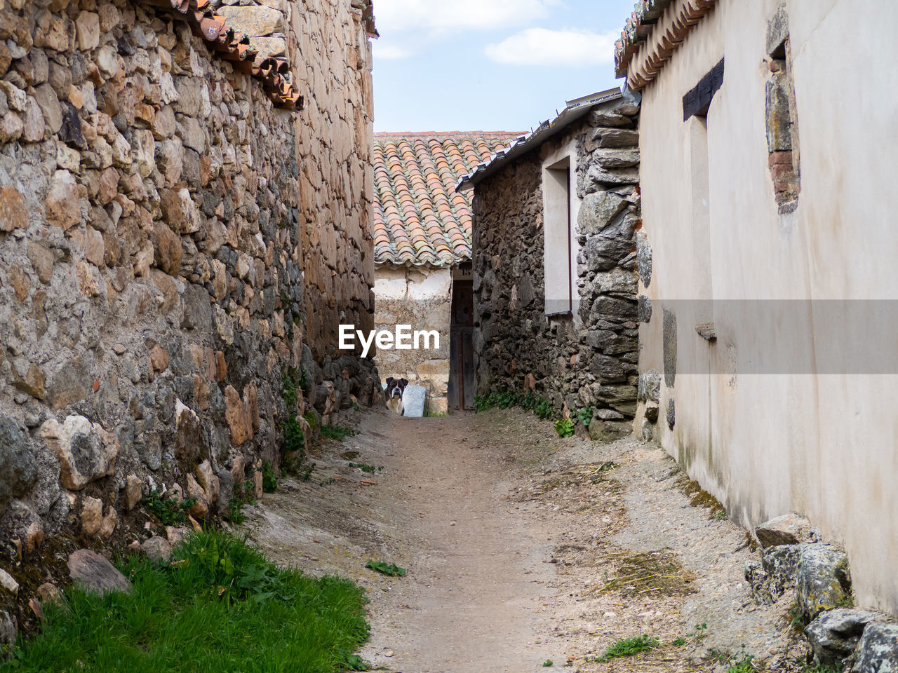 FOOTPATH AMIDST BUILDINGS IN TOWN