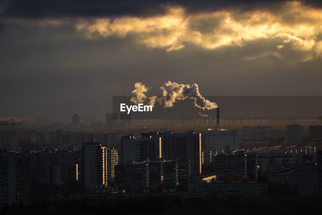 Smoke emitting from chimney against sky at sunset