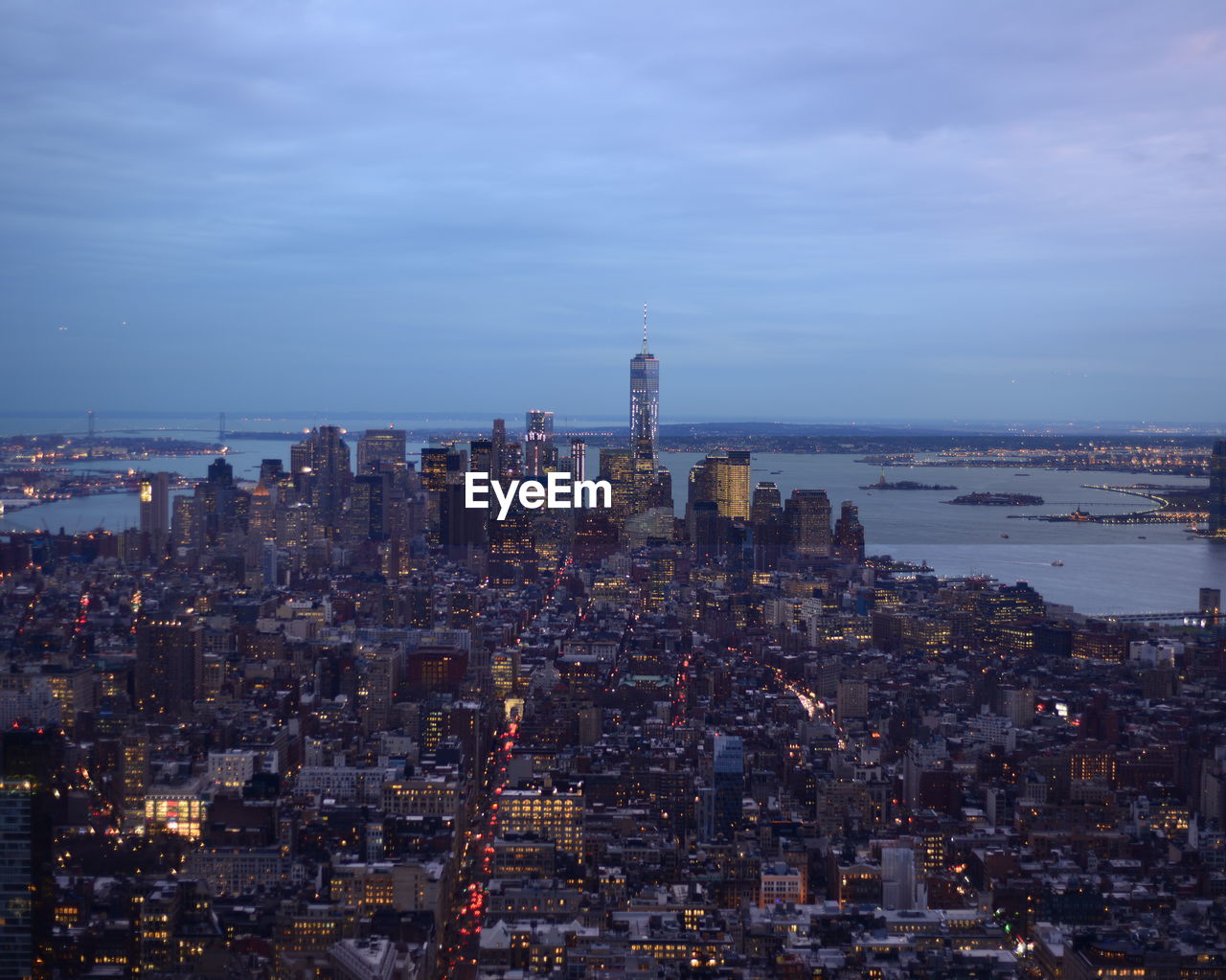 High angle view of illuminated buildings against river at manhattan