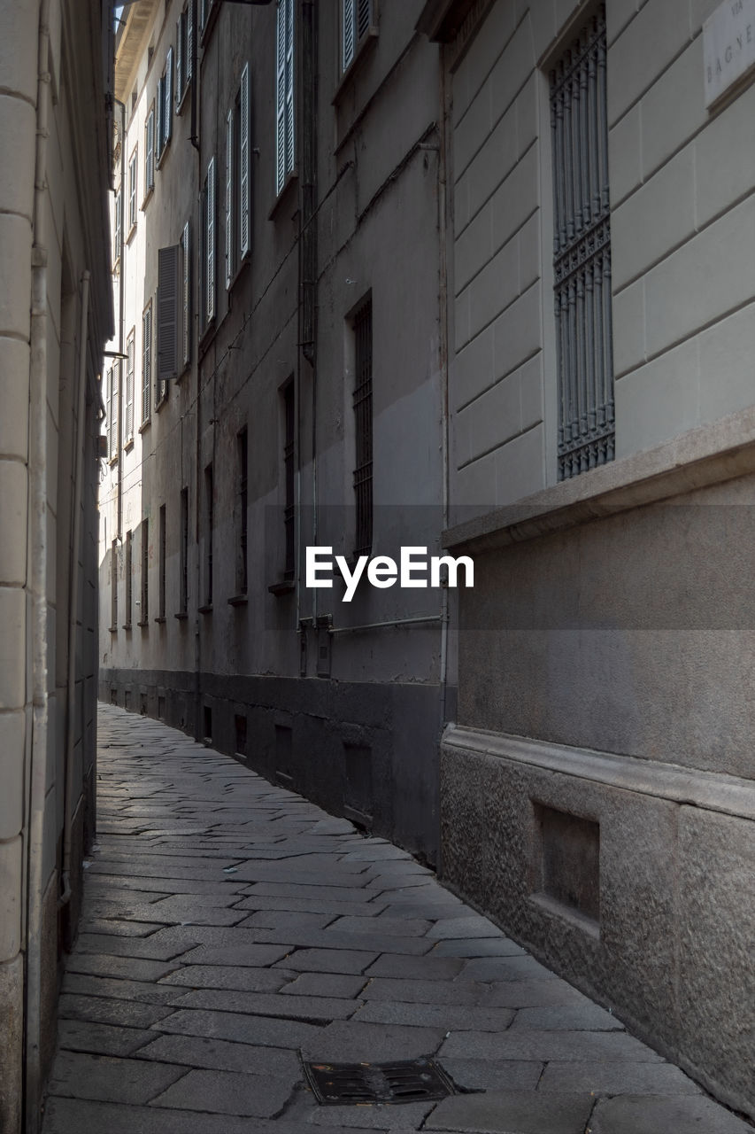 Empty alley amidst buildings in city