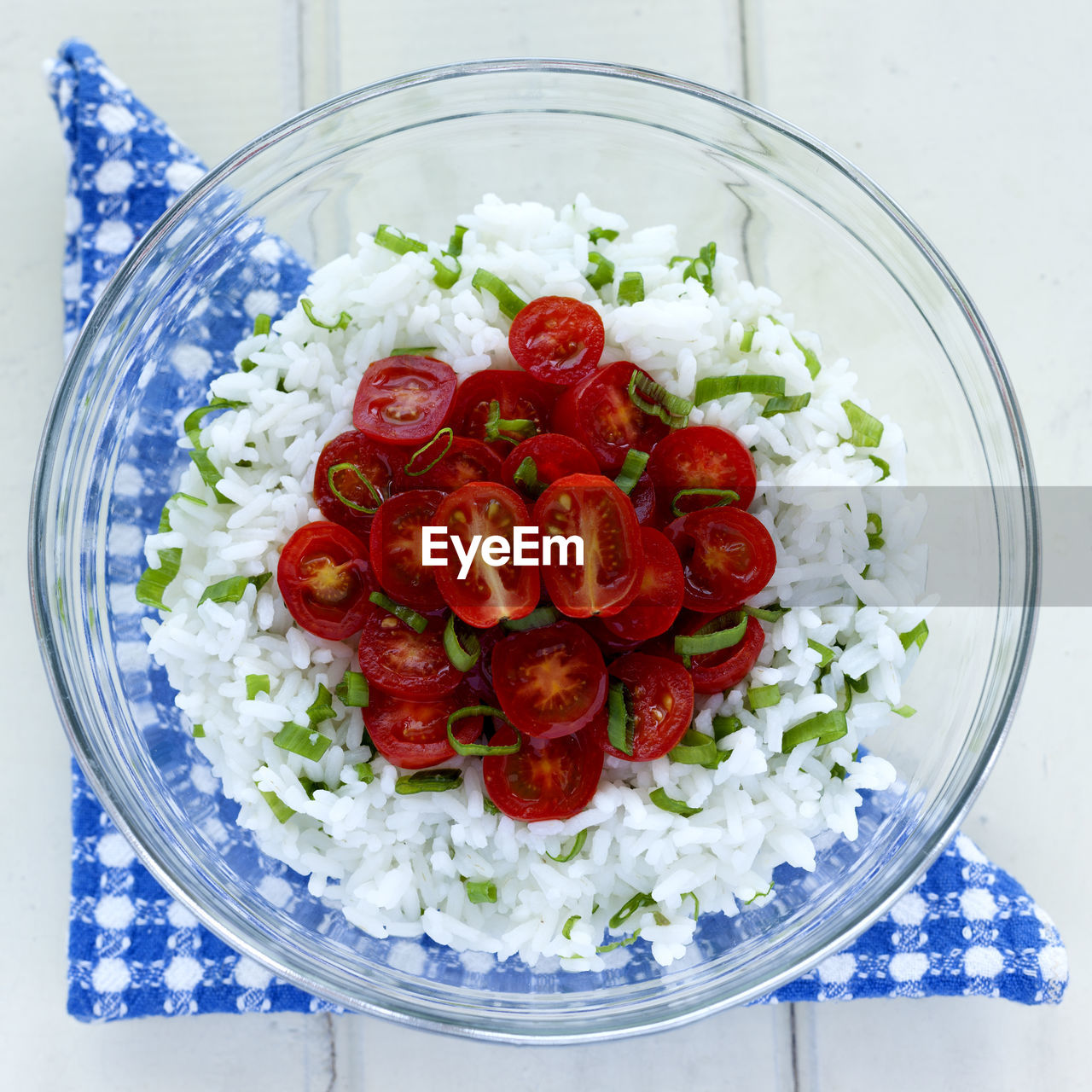 Directly above shot of tomatoes and rice in glass bowl on table