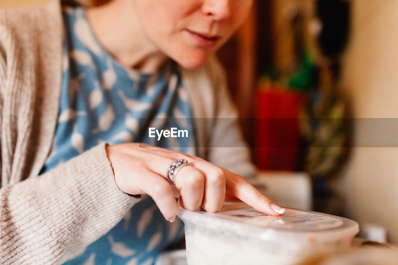 Close-up of woman holding hands on table