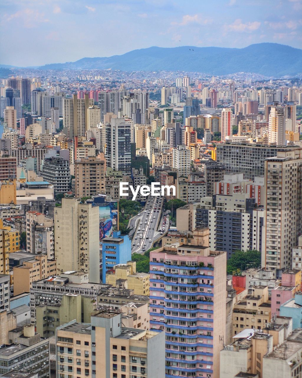 Aerial view of buildings in city against sky