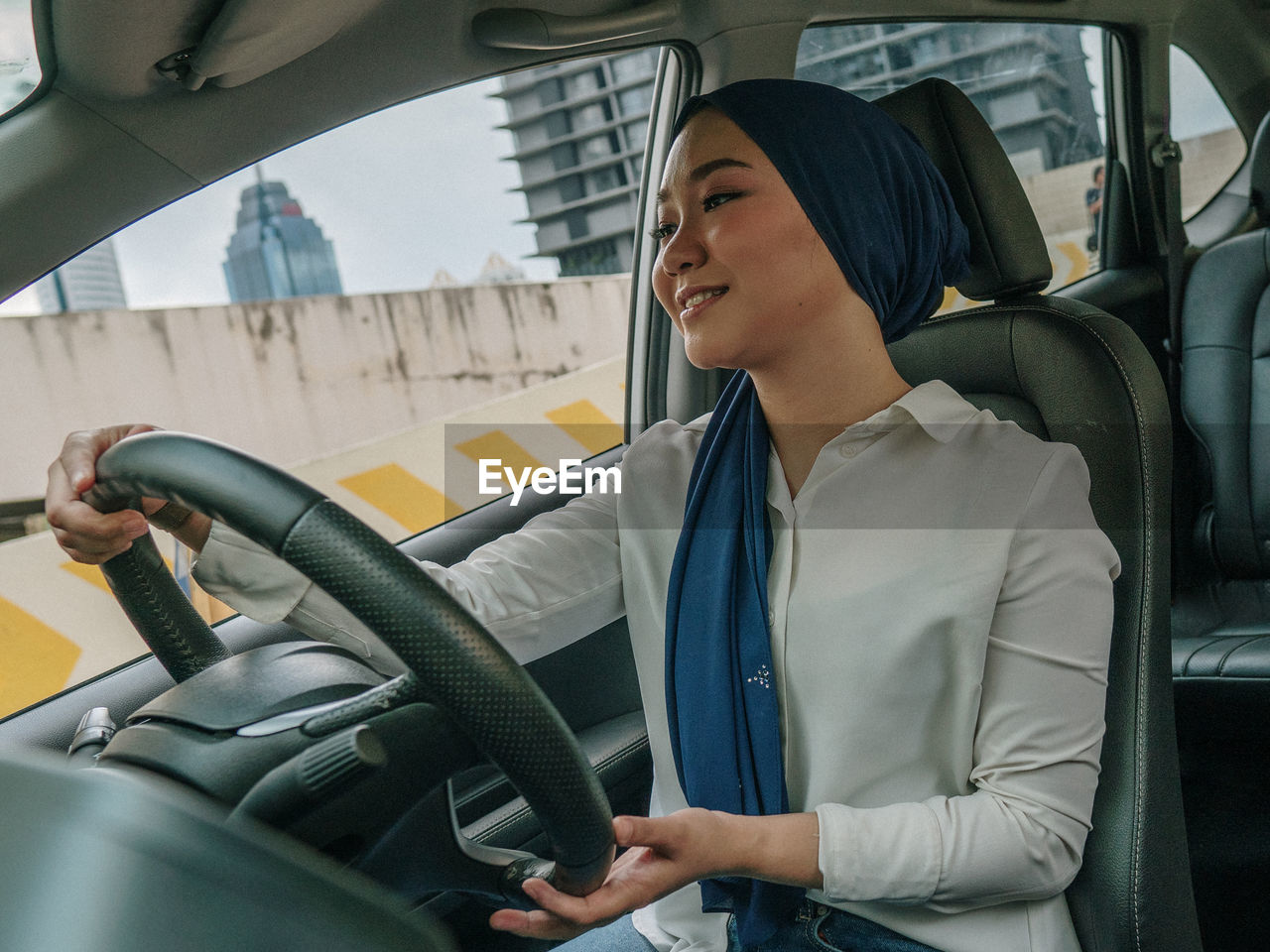 Midsection of woman sitting in car