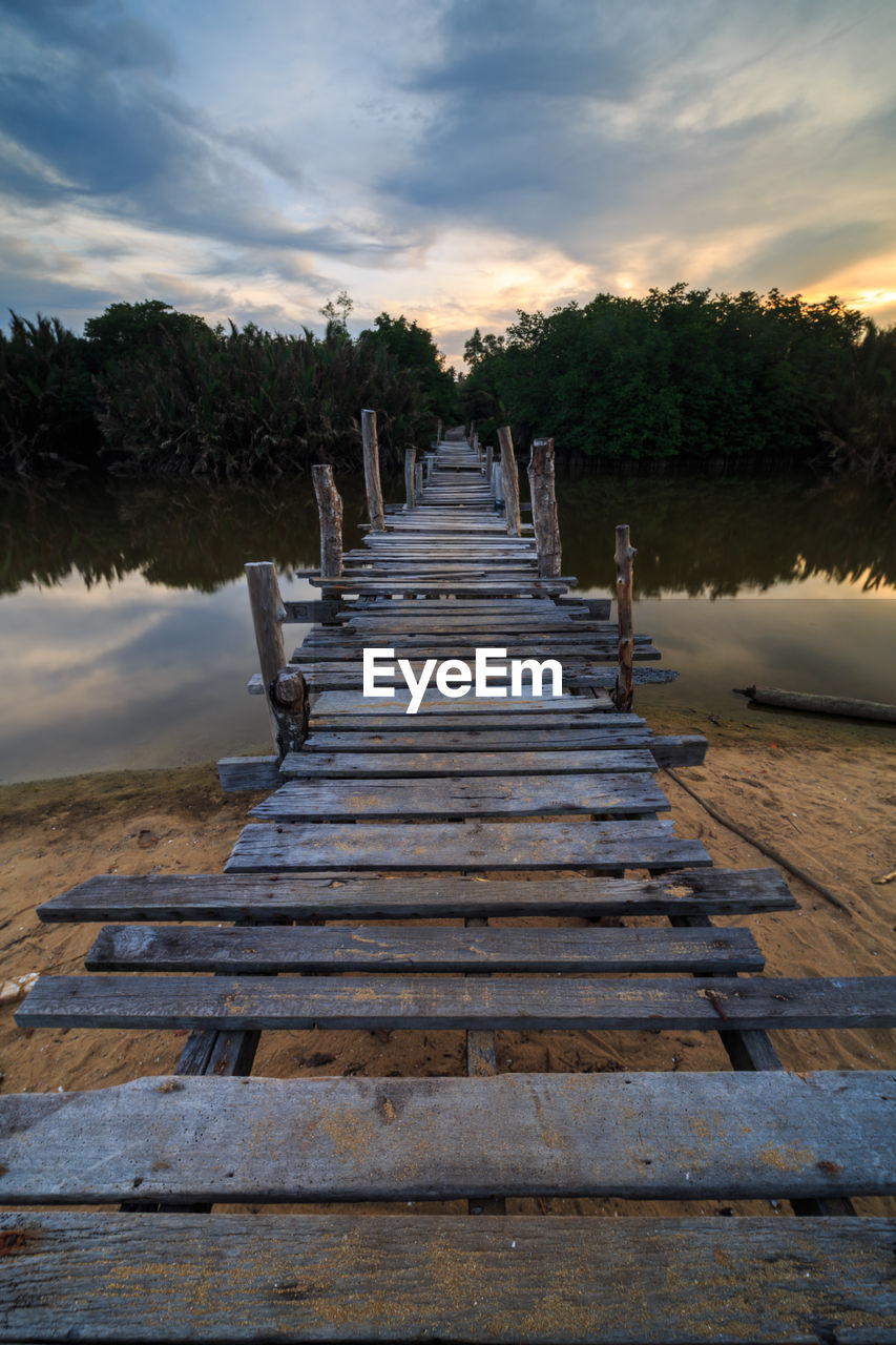 BOARDWALK AGAINST SKY DURING SUNSET