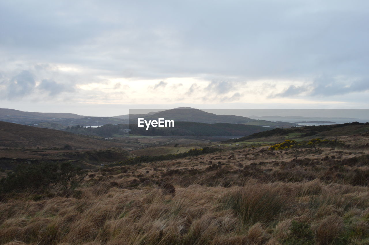 Scenic view of landscape and mountains against sky