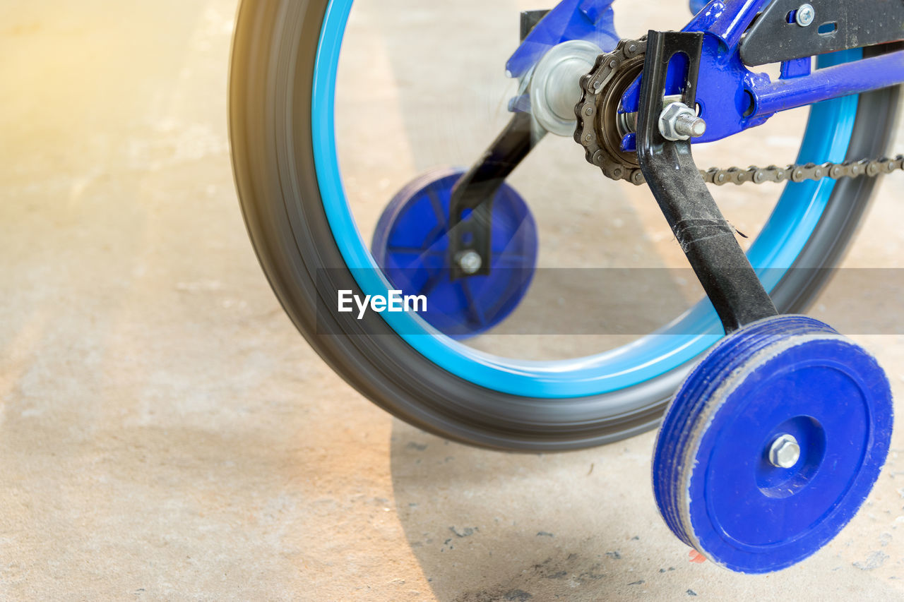 Close-up of bicycle wheel spinning outdoors