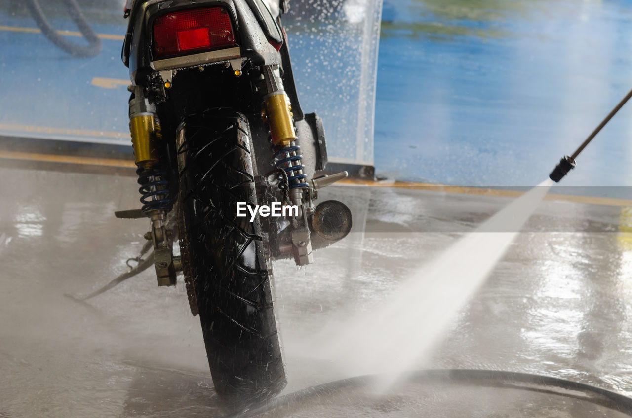 Water splashing on motorcycle in garage