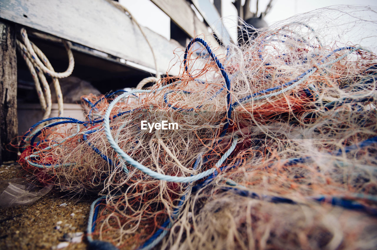 CLOSE-UP OF ROPES ON FISHING NET